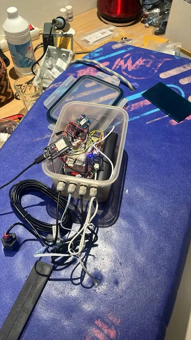 Prototype v0.1: electronics and sensors in a waterproof food container on a bodyboard